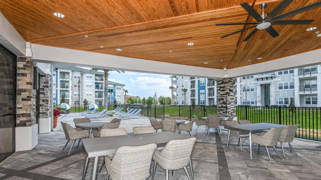 outdoor covered seating space in apartment community champions vue in davenport florida by kimaya