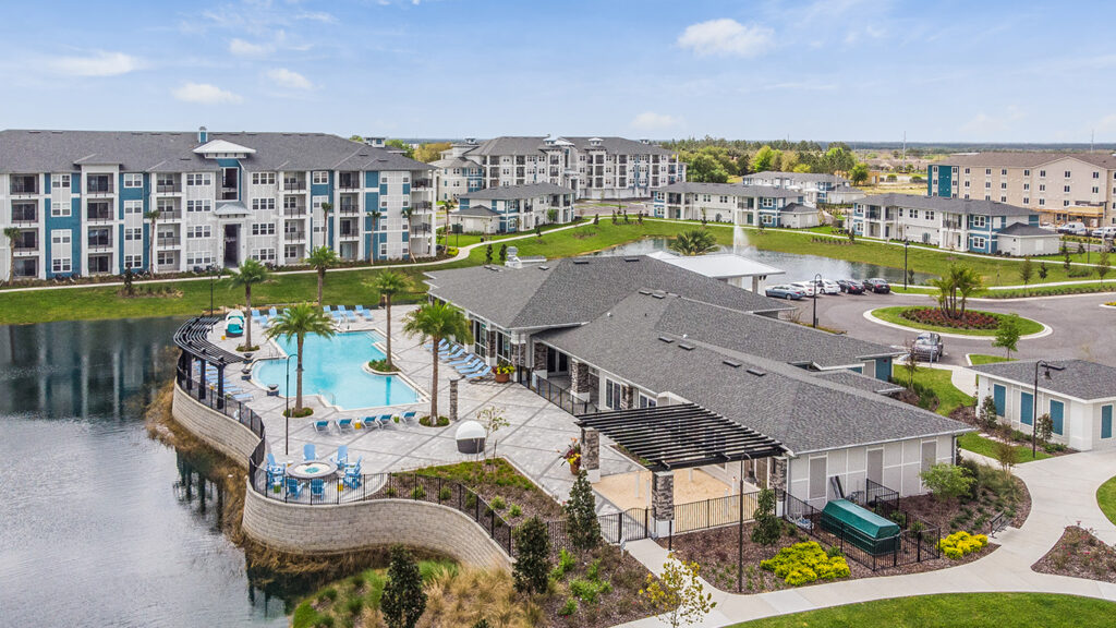 aerial view of champions vue apartment complex with lake and pool in davenport florida