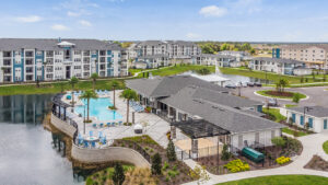 aerial view of champions vue apartment complex with lake and pool in davenport florida