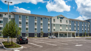 exterior view of hotel Woodspring Suites and parking lot in Sanford Florida built by kimaya