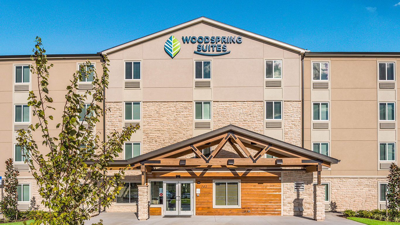 front entry and sign for woodspring suites hotel in davenport fl by park square homes kimaya